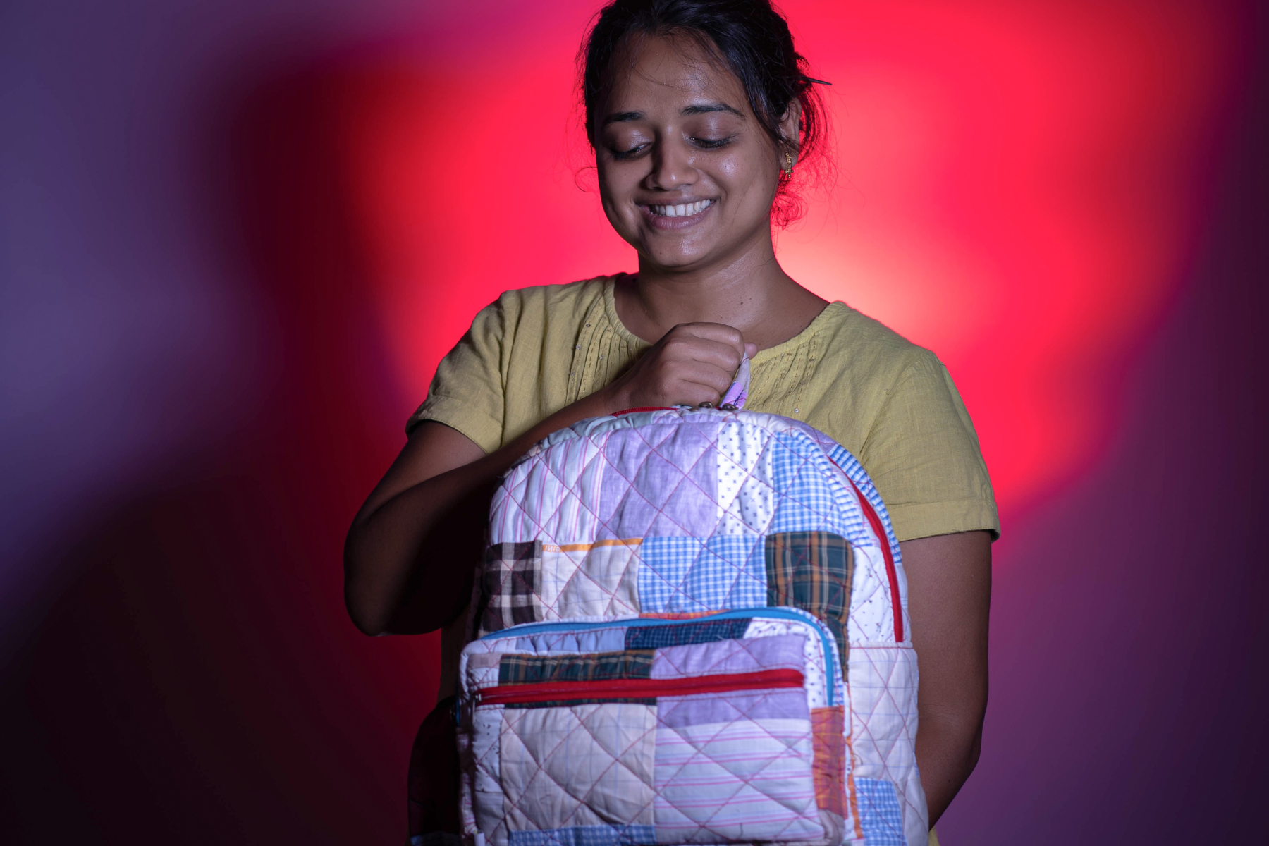 girl holding patchwork quilted backpack